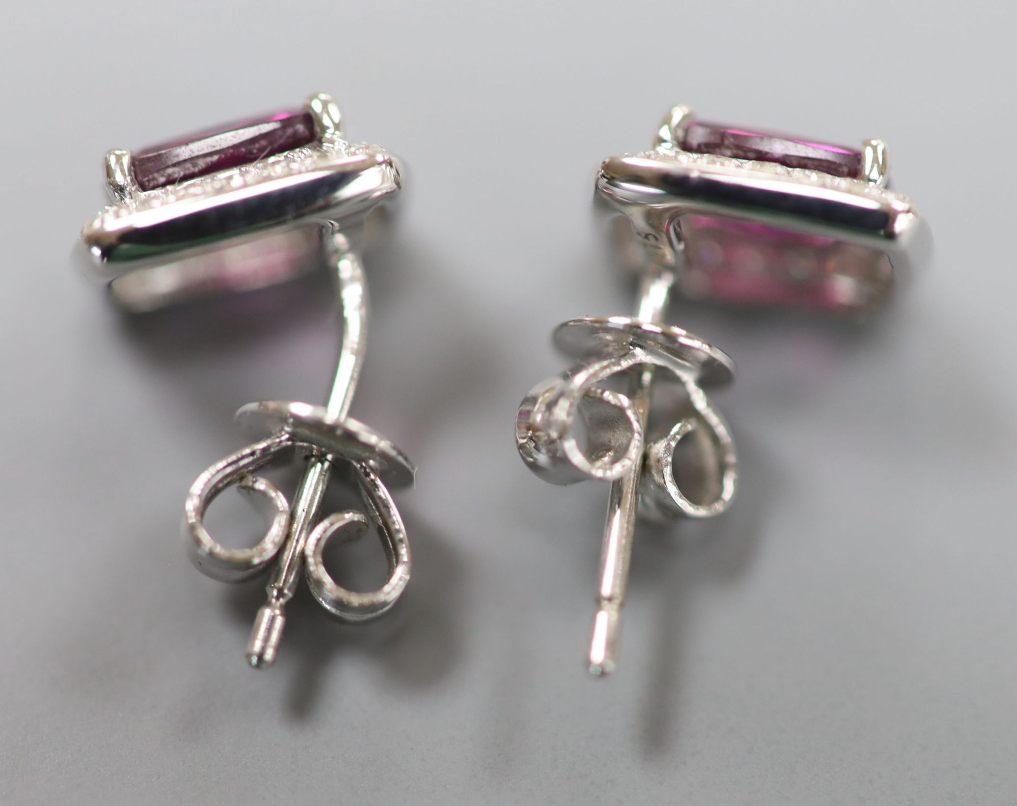 A pair of white metal (stamped 375), garnet and diamond set rectangular cluster ear studs, 8mm, gross 2 grams.